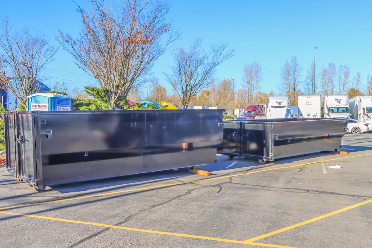 Professional dumpster rental service with roll-off container on residential driveway in Pompano Beach